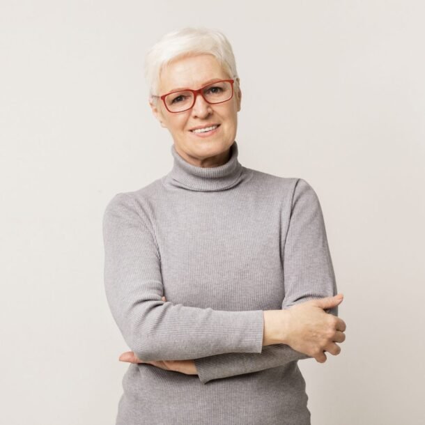 confident-elderly-woman-in-glasses-standing-with-f-ZP2XWAU